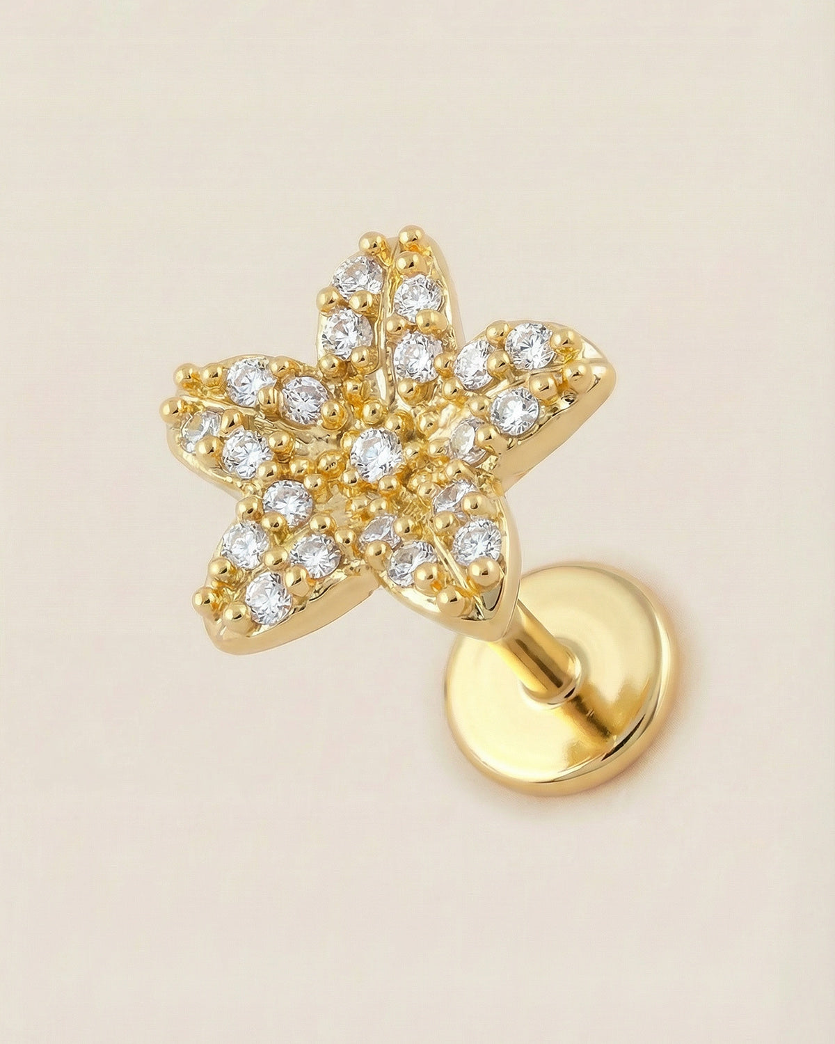 Altın renkli 316L cerrahi çelik çiçek formlu flatback piercing tasarımı.