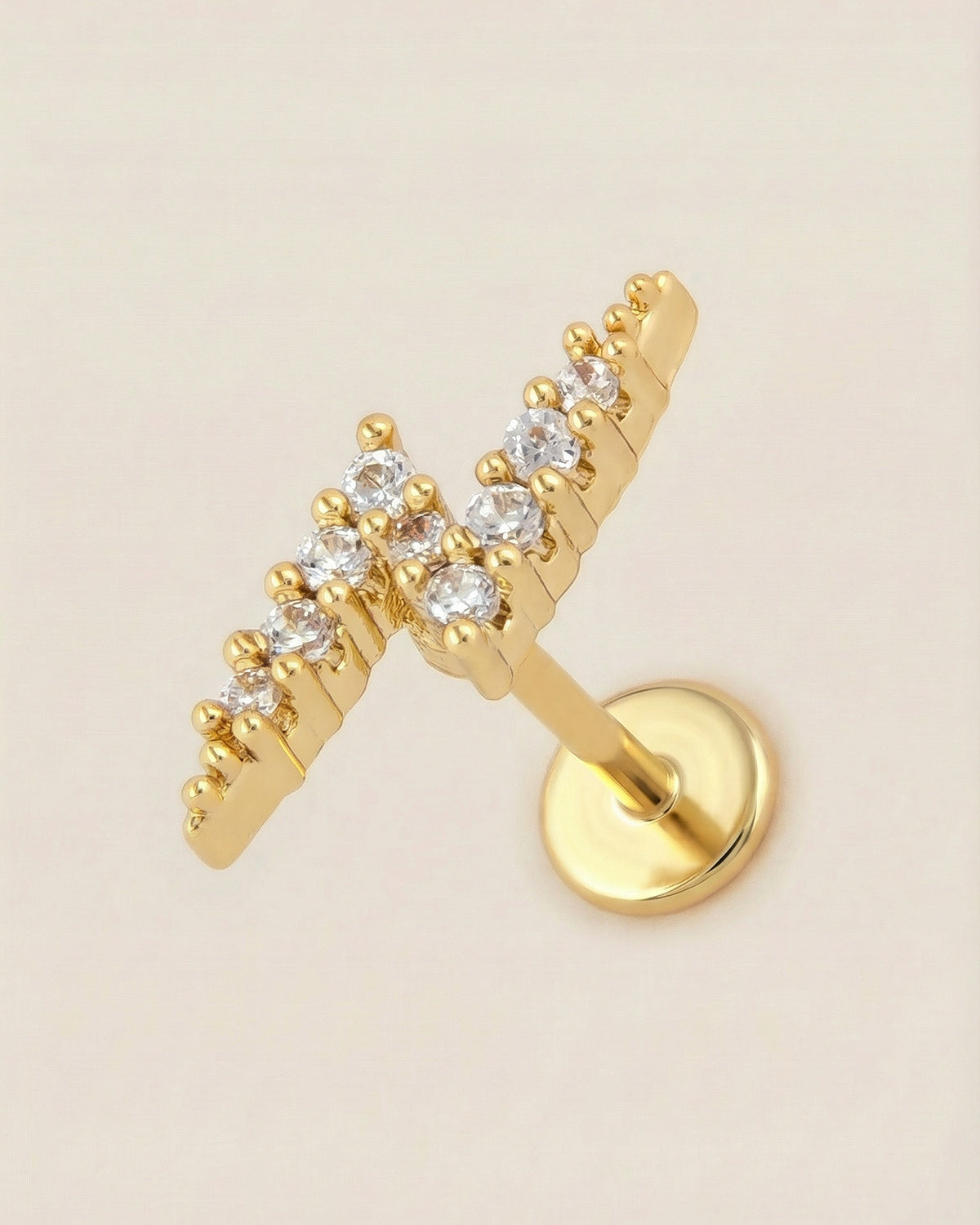 Altın renkli 316L cerrahi çelik şimşek formlu flatback piercing tasarımı.