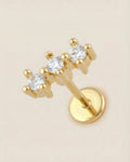 Altın renkli 316L cerrahi çelik üçlü sıra zirkon taşlı minimal flatback piercing.