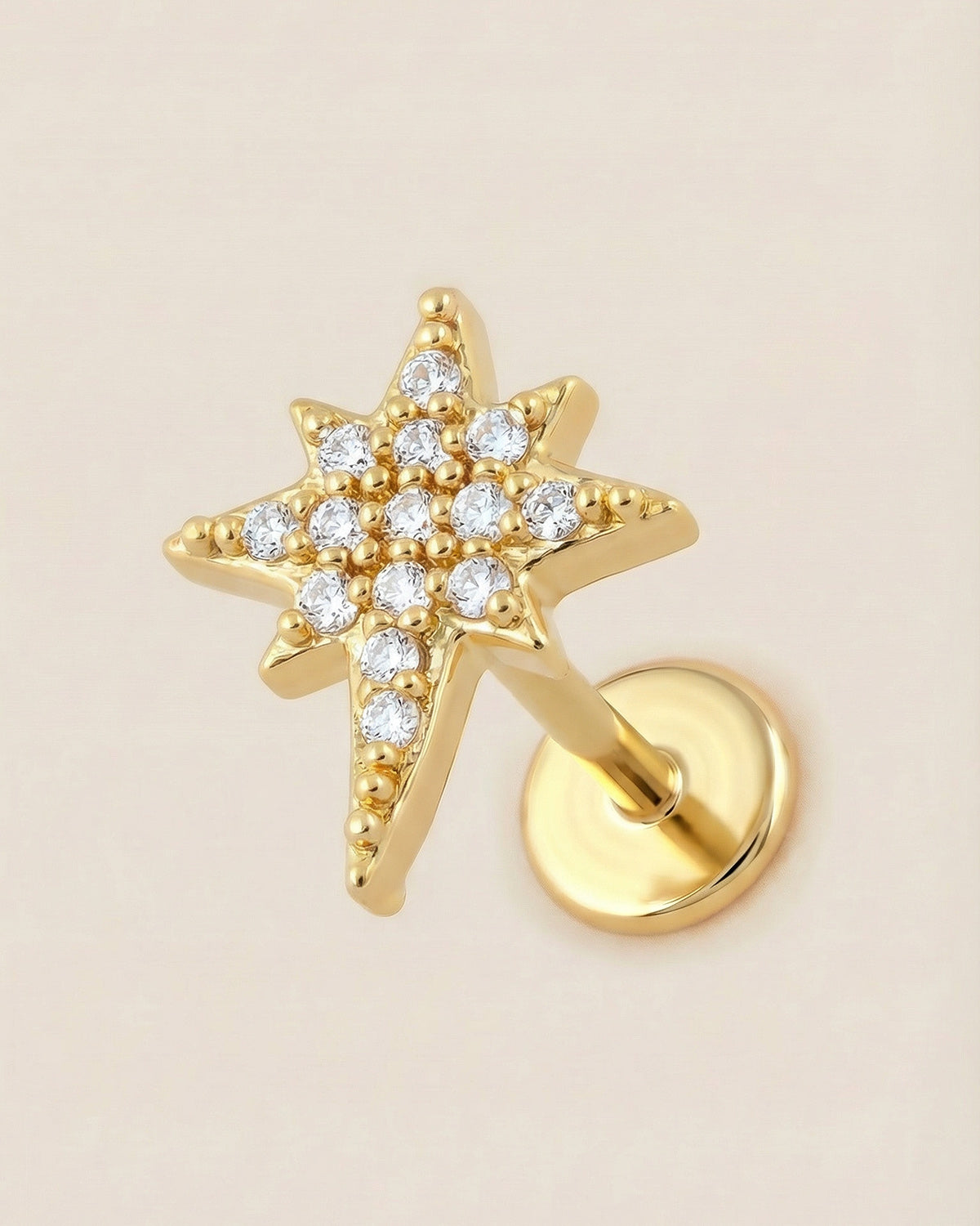 Altın renkli 316L cerrahi çelik zirkon taşlı kutup yıldızı flatback piercing.