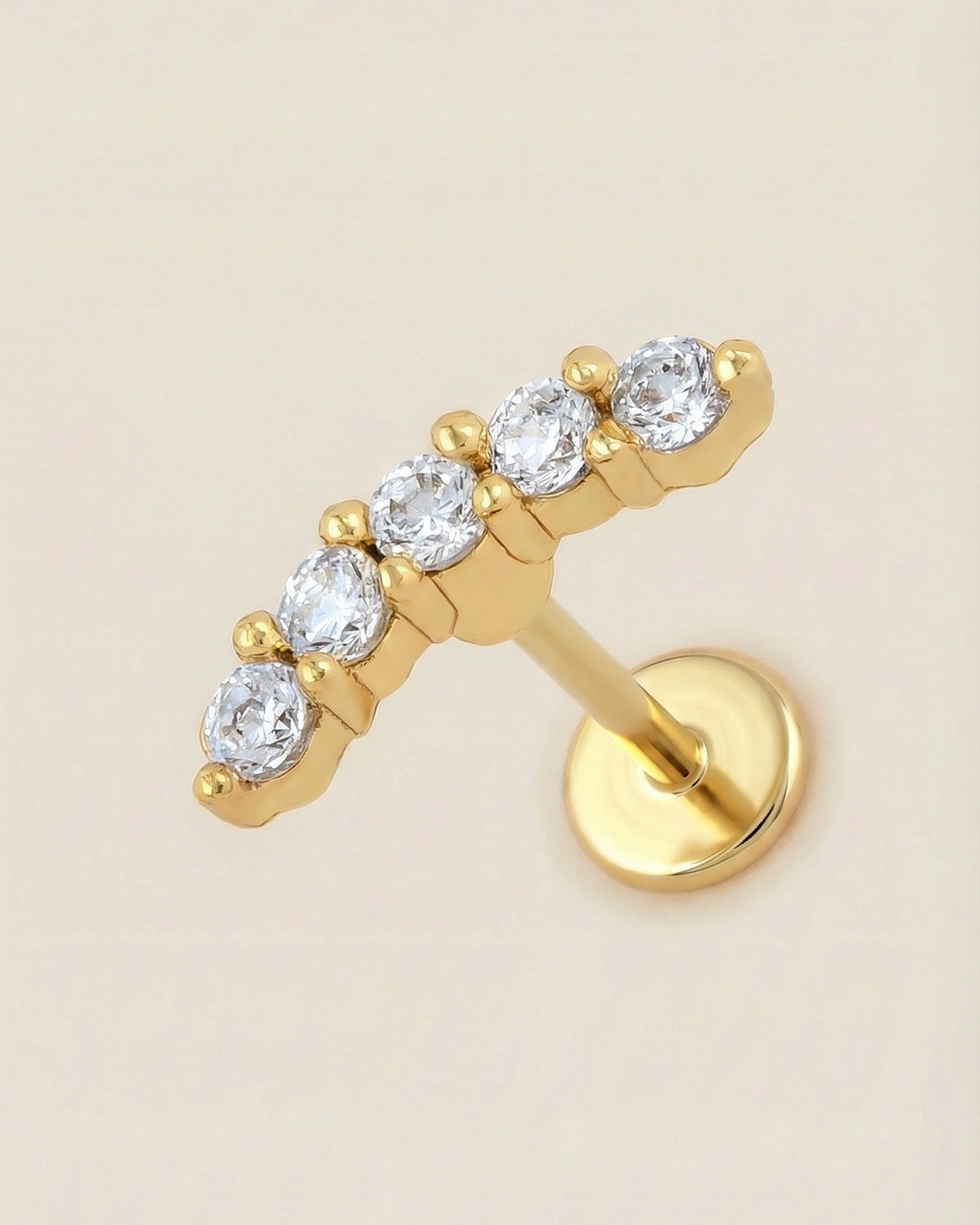 Altın renkli 316L cerrahi çelik zirkon taşlı minimal kavisli flatback piercing.