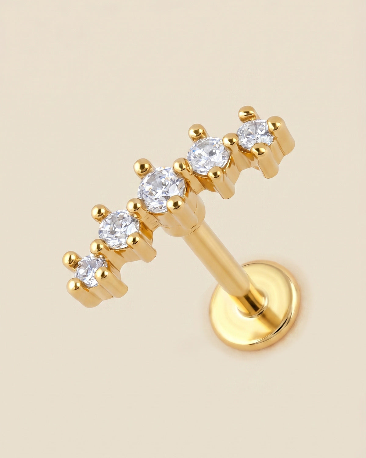 Altın renkli 316L cerrahi çelik kavisli 5 zirkon taşlı flatback piercing tasarımı.