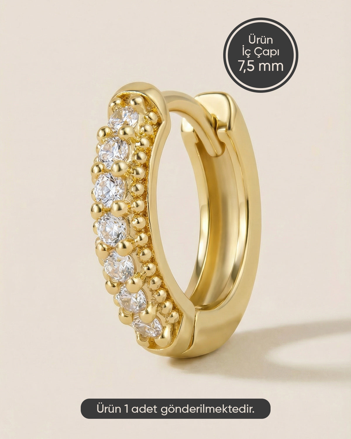 Altın renkli 316L cerrahi çelik kenarı topçuk detaylı zirkon taşlı halka piercing tasarımı.
