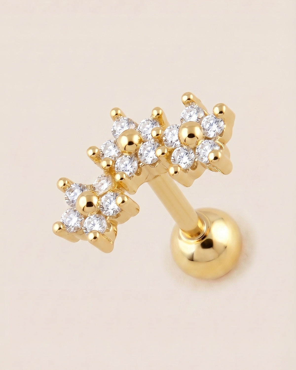 Altın renkli cerrahi çelik zirkon taşlı kavisli çiçekli tragus piercing tasarımı.