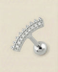 Gümüş renkli 316L cerrahi çelik kavisli zirkon taşlı tragus piercing tasarımı.