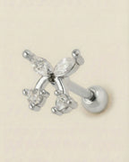 Gümüş renkli 316L cerrahi çelik yuvarlak zirkon taşlı kiraz formlu tragus piercing tasarımı.