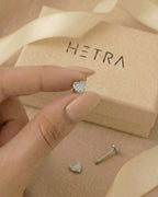 Zirkon taşlı kalp gümüş renkli flatback piercingin elde gerçek boyutu.